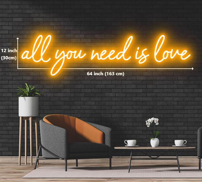 Neon sign with the words 'all you need is love' glowing in vibrant colors.